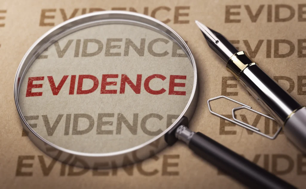 A magnifying glass highlights the word "EVIDENCE" on paper